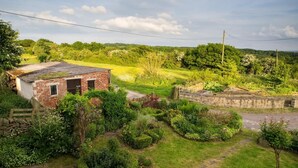 A rural landscape with a small brick building, a stone wall, and a well-maintained garden. - 2 Bed in Holmesfield (oc-pk783) (Dronfield)