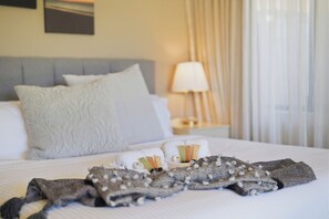 A neatly made bed with pillows, a folded blanket, and toiletries on the bedside table. - Murray River family retreat with private pool, kayaks, paddleboards and reserve views (South Yunderup)