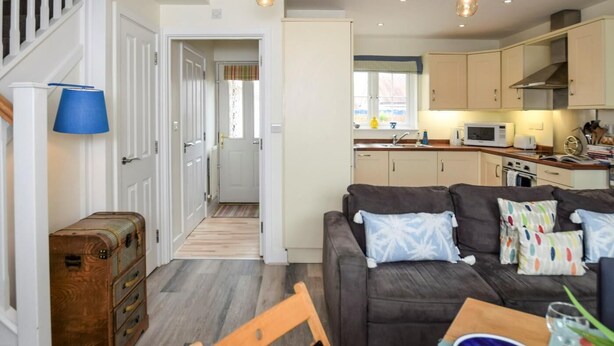 A compact living space with a sofa, dining table, and kitchenette. - 2 Bed in Camber (oc-bt084) (Camber)
