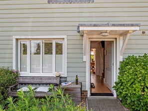 A house with a front porch, a bench, a door, and a small garden area. - 4 Bed in Rye- (oc-bt104) (Rye)