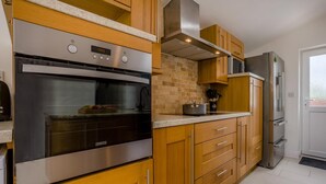 Una cucina moderna con forno, microonde e frigorifero.