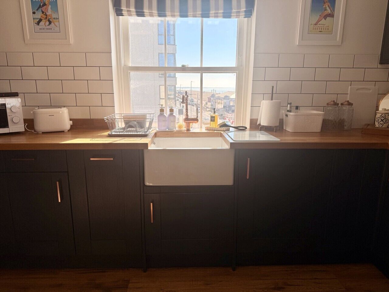 A kitchen with a window, a sink, and a toaster.