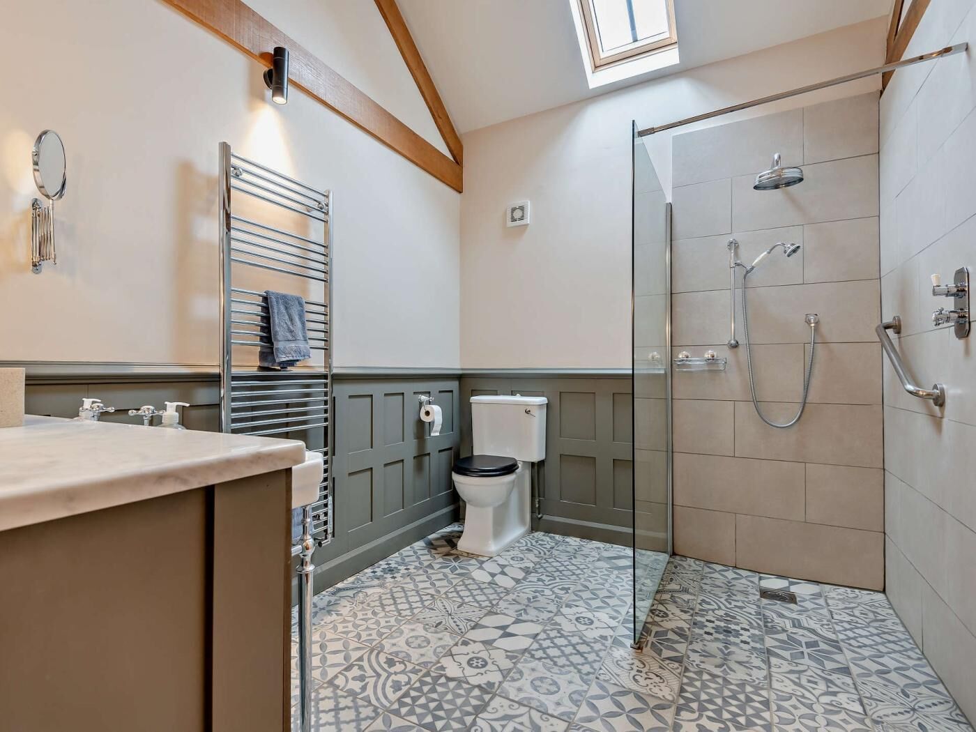 A bathroom with a shower, toilet, and sink.