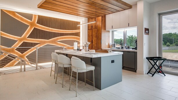 A modern kitchen with a central island, bar stools, and a view of the outdoors. - Trackside Luxury at Atlanta Motorsports Park (Dawsonville)