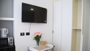 A kitchenette with a microwave, coffee maker, and a small refrigerator. - LA TORRETTA (Savona)