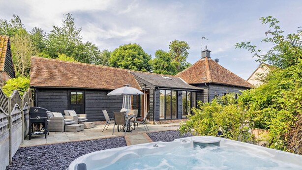 A hot tub, outdoor seating, and a building with a tiled roof. - 1 Bed in Dunmow (oc-51222) (Thaxted)