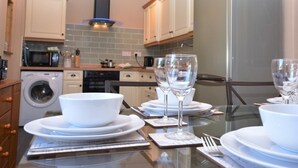 A modern kitchen with a stainless steel refrigerator, a washing machine, and a microwave. - 3 Bed in Wylam (oc-51738) (Wylam)