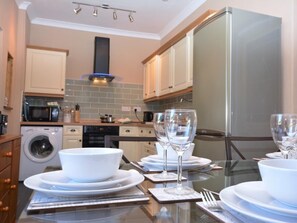 A modern kitchen with a stainless steel refrigerator, a washing machine, and a microwave. - 3 Bed in Wylam (oc-51738) (Wylam)