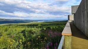 A wooden deck overlooking a forested landscape with a clear sky. - 3 Bed in Wylam (oc-51738) (Wylam)
