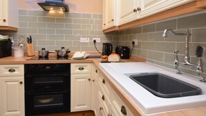 A kitchen with a dishwasher, oven, stove, and a sink with a faucet. - 3 Bed in Wylam (oc-51738) (Wylam)