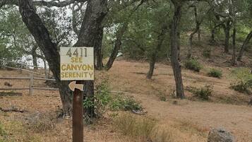 A signpost with the number 4411 and the text 'SEE CANYON SERENITY' pointing to the right.
