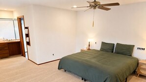 A bedroom with a bed, a ceiling fan, a nightstand, and a dresser. - 14-Acre Estate with Private Pool near Pismo Beach (San Luis Obispo)
