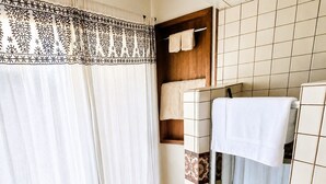 A bathroom with a wooden floor, a glass shower enclosure, and a tiled wall with a patterned border. - 14-Acre Estate with Private Pool near Pismo Beach (San Luis Obispo)