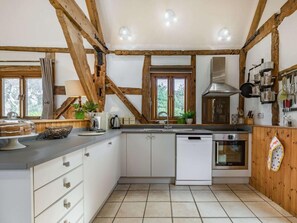 A kitchen with wooden beams, a sink, a stove, and a dishwasher. - 4 Bed in Ludlow (oc-chl22) (Orleton)