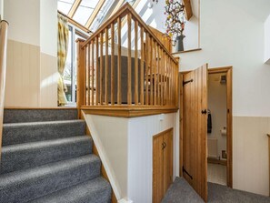 A staircase with wooden railings, carpeted steps, and a skylight above. - 4 Bed in Ludlow (oc-chl22) (Orleton)