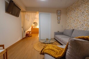 A living room with a grey sofa, a glass coffee table, and a wooden floor. - Alicante Rent - Villa Costa Luz (Alicante)