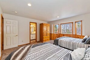 A bedroom with two beds, a walk-in closet, and large windows. - Big Bear Ski Chalet - Walk to Slopes & Hot Tub (Big Bear Lake)