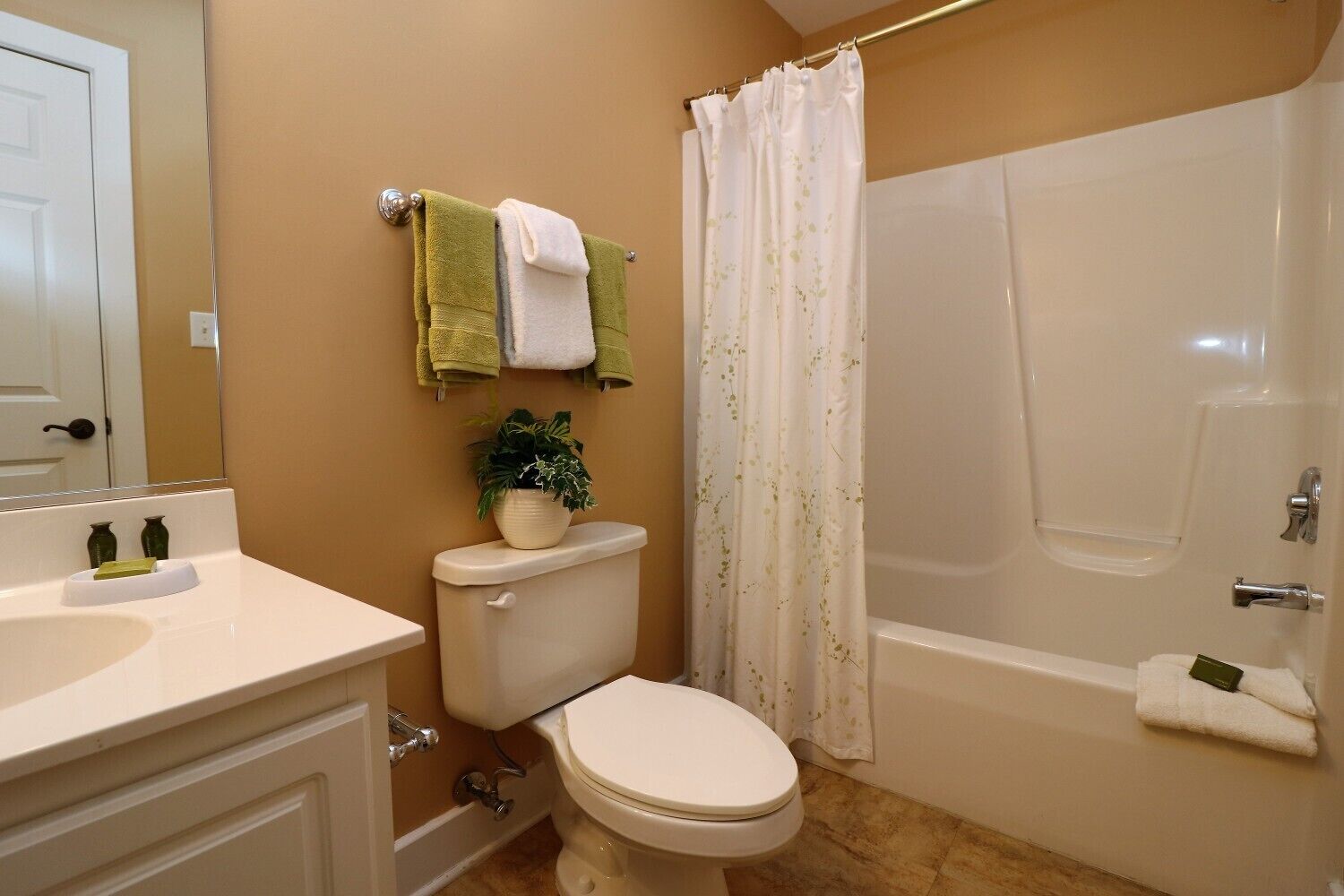 A bathroom with a toilet, sink, and bathtub.