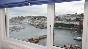 A bay with boats, a pier, and colorful buildings in the background. - 3 Bed in Brixham (oc-bx018) (Brixham)