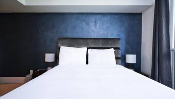 Departamento Deluxe, varias camas | Tabla de planchar con plancha, wifi gratis y ropa de cama