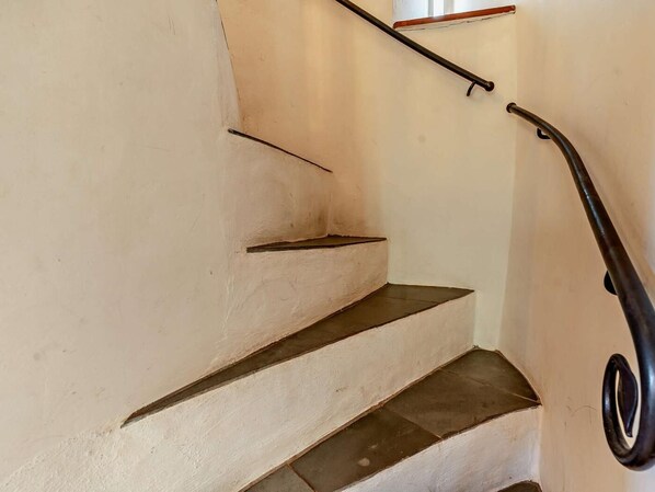 A staircase with a handrail and a small landing.