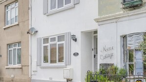 Un edificio blanco con un cartel que dice 'Noe Cottage'.