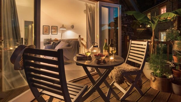 A cozy outdoor seating area with a table, chairs, and potted plants. - 1 Bed in Coniston (oc-lcc37) (Blawith)