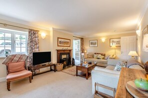 A cozy living room with a fireplace, a television, and comfortable seating. - 2 Bed in Nr Kendal (oc-lcc35) (Crosthwaite)