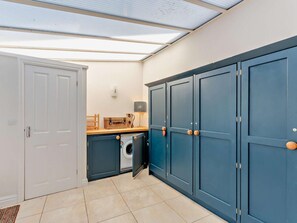 A compact kitchen with a washing machine, cabinets, and a countertop. - 2 Bed in Cartmel (oc-lcc47) (Cartmel)