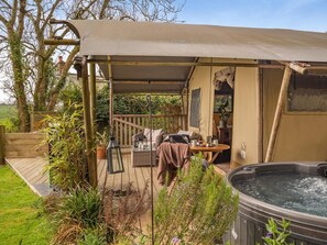 A covered outdoor area with a hot tub, wooden deck, and seating. - 1 Bed in St. Austell (oc-58376) (Pentewan Valley)