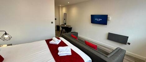 Junior Apartment, City View | Blackout drapes, iron/ironing board, WiFi (free), bed sheets