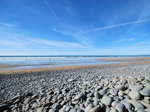 Ein felsiger Strand unter blauem Himmel.