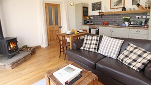 A cozy living room with a fireplace, a dining area, and a kitchenette. - 1 Bed in Belford (oc-cn008) (Adderstone with Lucker)