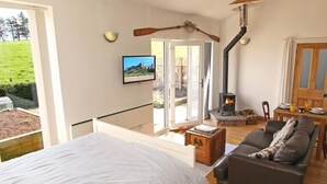 A cozy room with a bed, a sofa, a fireplace, and a television. - 1 Bed in Belford (oc-cn008) (Adderstone with Lucker)