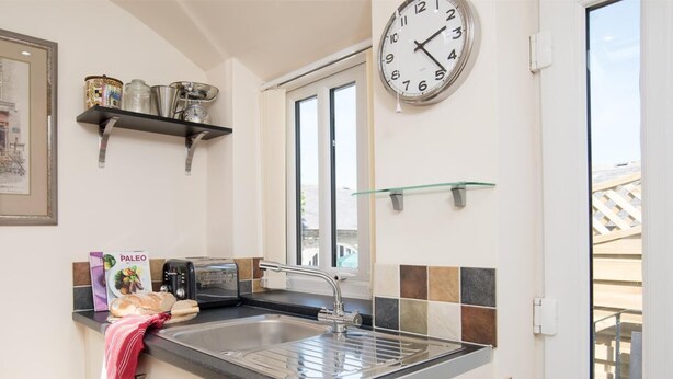 A kitchen with a sink, a toaster, a clock, and a window. - 1 Bed in Riding Mill (oc-cn063) (Corbridge)