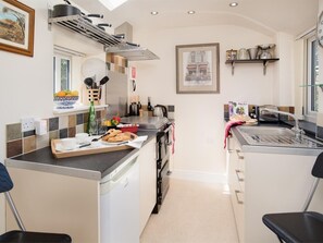 A compact kitchen with a built-in oven, a sink, and a window. - 1 Bed in Riding Mill (oc-cn063) (Corbridge)