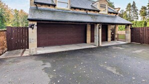 A two-story house with a garage, a driveway, and a fenced yard. - 1 Bed in Alnwick (oc-cn215) (Alnwick)