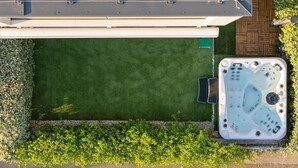 A rooftop patio with a hot tub, a green lawn, and a wooden deck. - Pure Bliss Villa With Jacuzzi (Tisno)