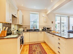 A modern kitchen with white cabinets, a marble countertop, a built-in oven, and a window with blinds. - 2 Bed in Alnwick (oc-cn218) (Alnwick)
