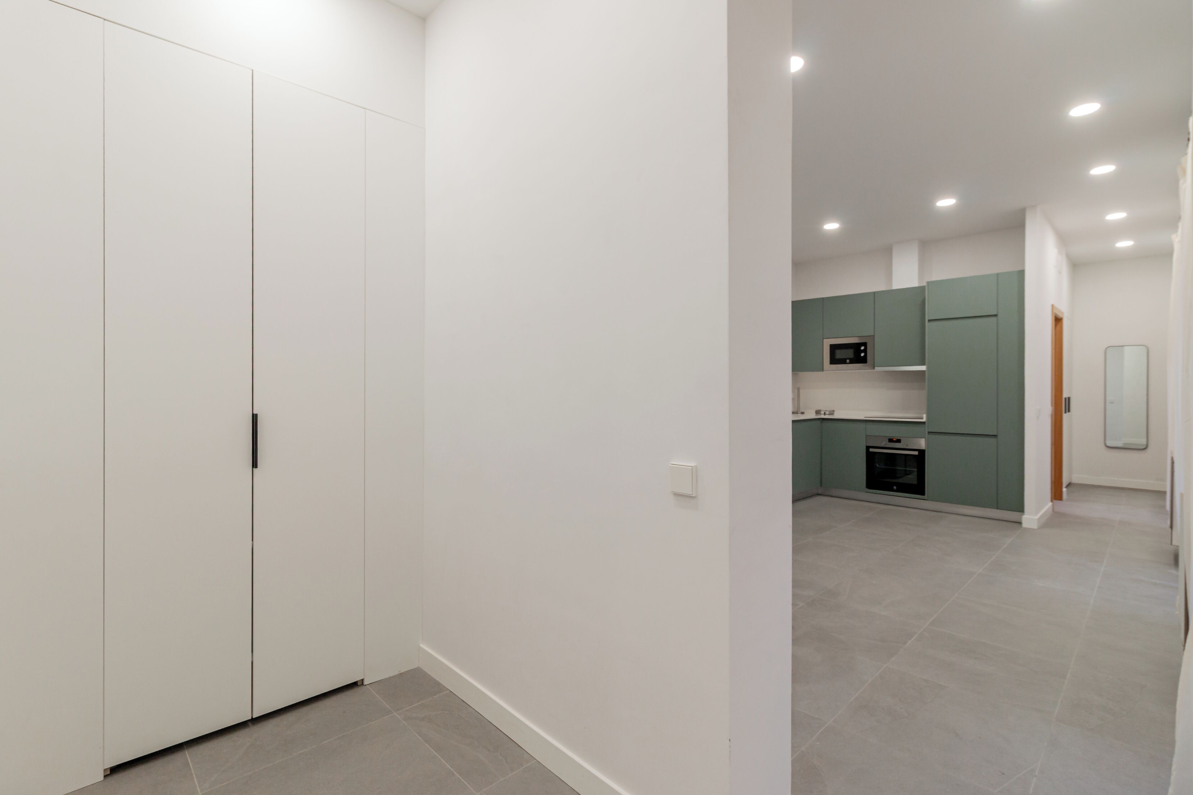 Una cocina moderna con electrodomésticos integrados y un comedor independiente.