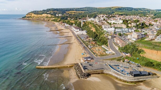 An aerial view of a coastal town with a beach, a marina, and residential buildings. - 4 Bed in Shanklin (oc-ic068) (Shanklin)