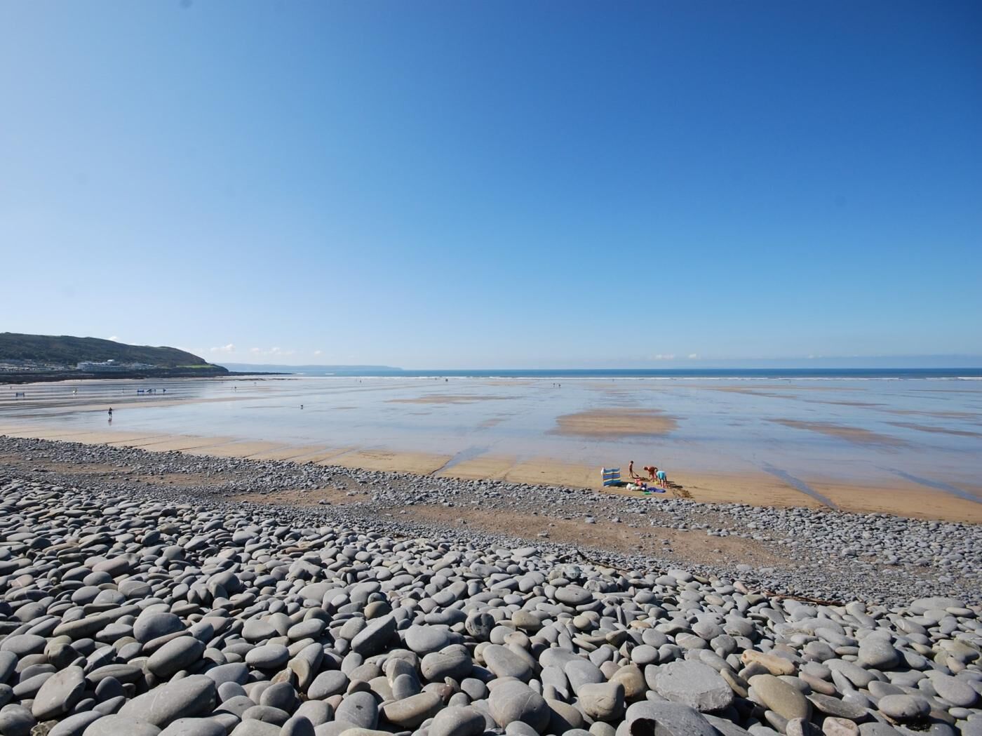 A rocky beach with a clear sky.