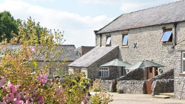A stone building with a sloped roof, a door, and a window. - 3 Bed in Buxton (oc-pk656) (Blackwell)