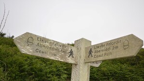 A wooden directional signpost with two arms, one pointing to Abercastell 5m and the other to Aberleidd 2m along the Coast Path. - 1 Bed in Haverfordwest (oc-61170) (Porthgain)