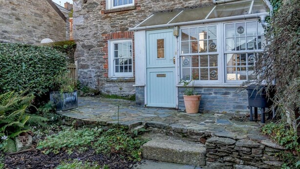 A stone building with a conservatory, a small garden, and a stone pathway. - 2 Bed in Polruan (oc-pc033) (Fowey)