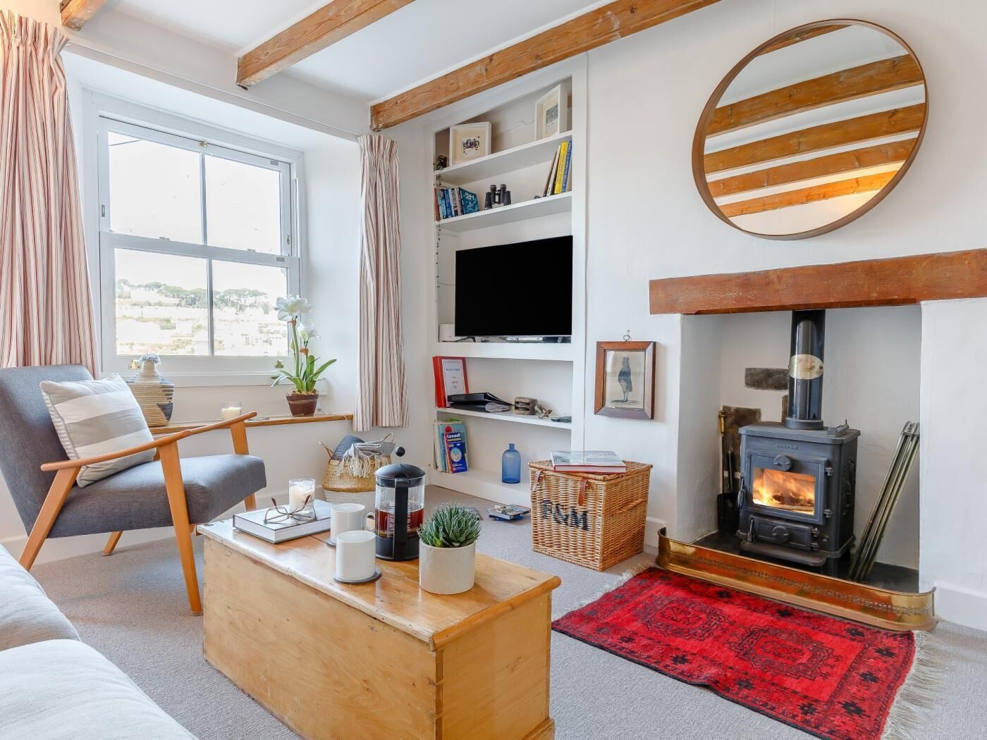 A cozy living room with a fireplace, a television, and a comfortable seating area.