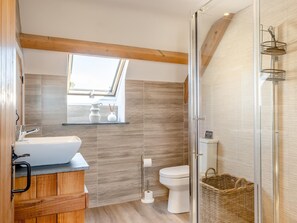 A modern bathroom with a wooden vanity, a window, a toilet, and a shower area. - 2 Bed in Godshill (oc-ic149) (Godshill)