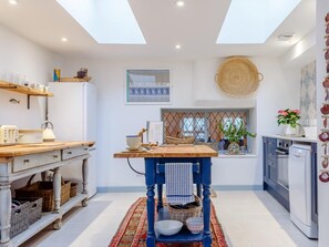 A kitchen with a skylight, wooden counter, and a blue stool. - 3 Bed in Fowey (oc-pc063) (Fowey)