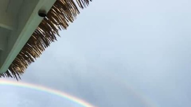 A clear view of turquoise ocean water with a rainbow. - Happy House in Grand Case Beach 1 (Grand Case)