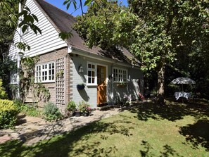 A house with a brick exterior, white siding, and a front door. - 1 Bed in Etchingham (oc-62641) (Burwash)